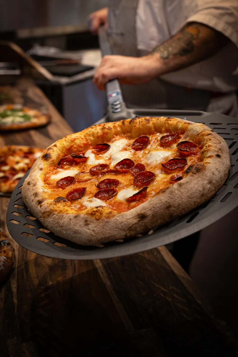 Margherita pizza with fresh basil and charred leoparding from the wood-fired oven
