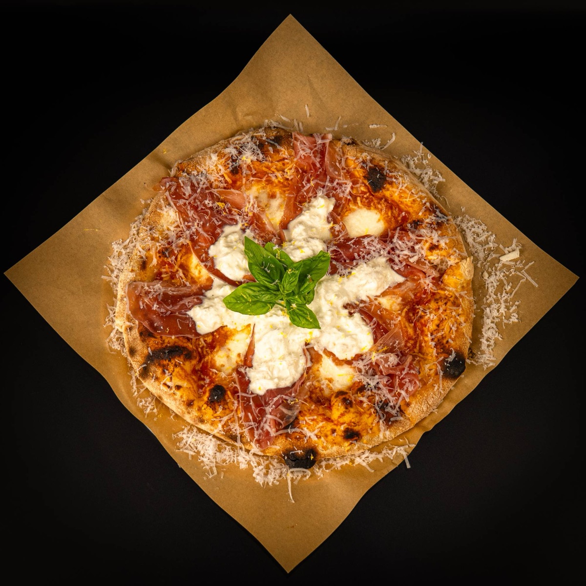 A wood-fired Bravado pizza with prosciutto, burrata and basil