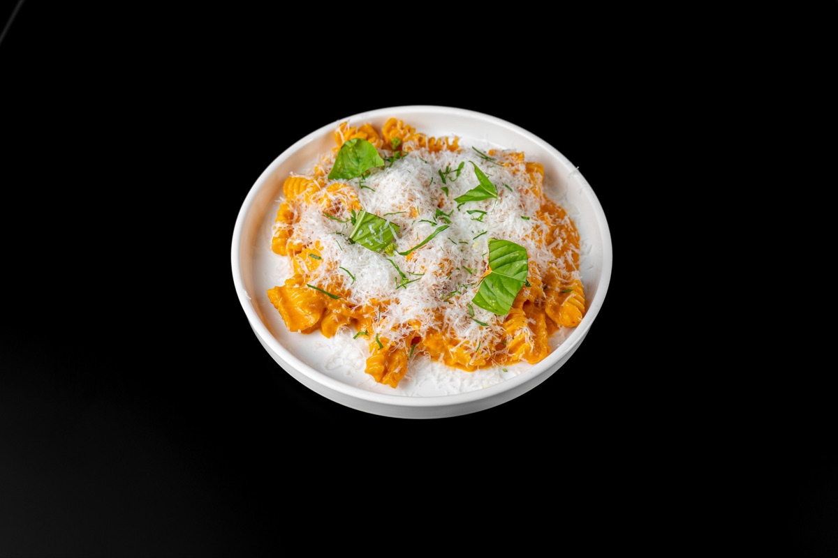 Radiatori pasta in a creamy tomato sauce with grated cheese and basil
